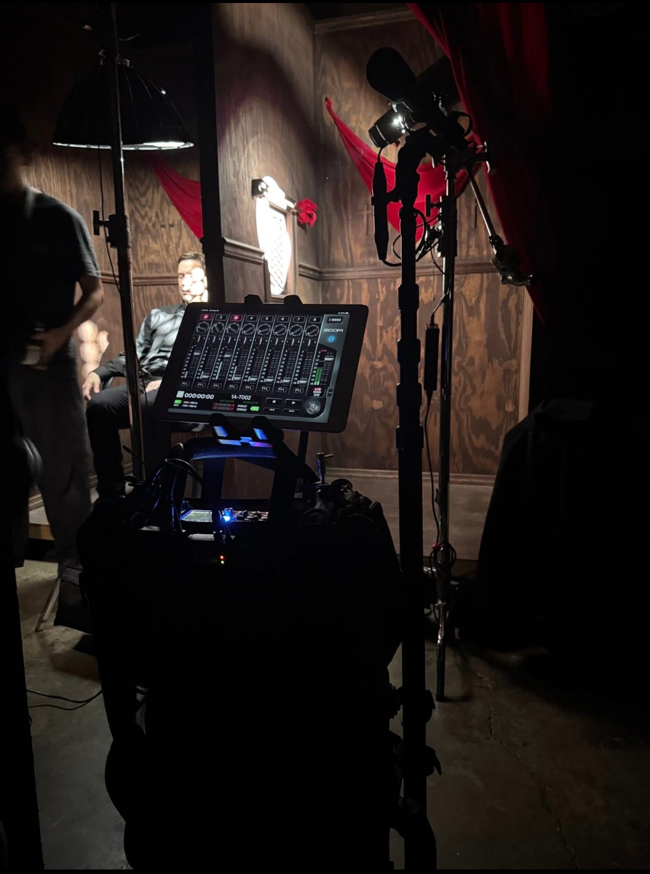 Full bag rig running multi-track to an iPad mixer surface on set, with boom mic and stands